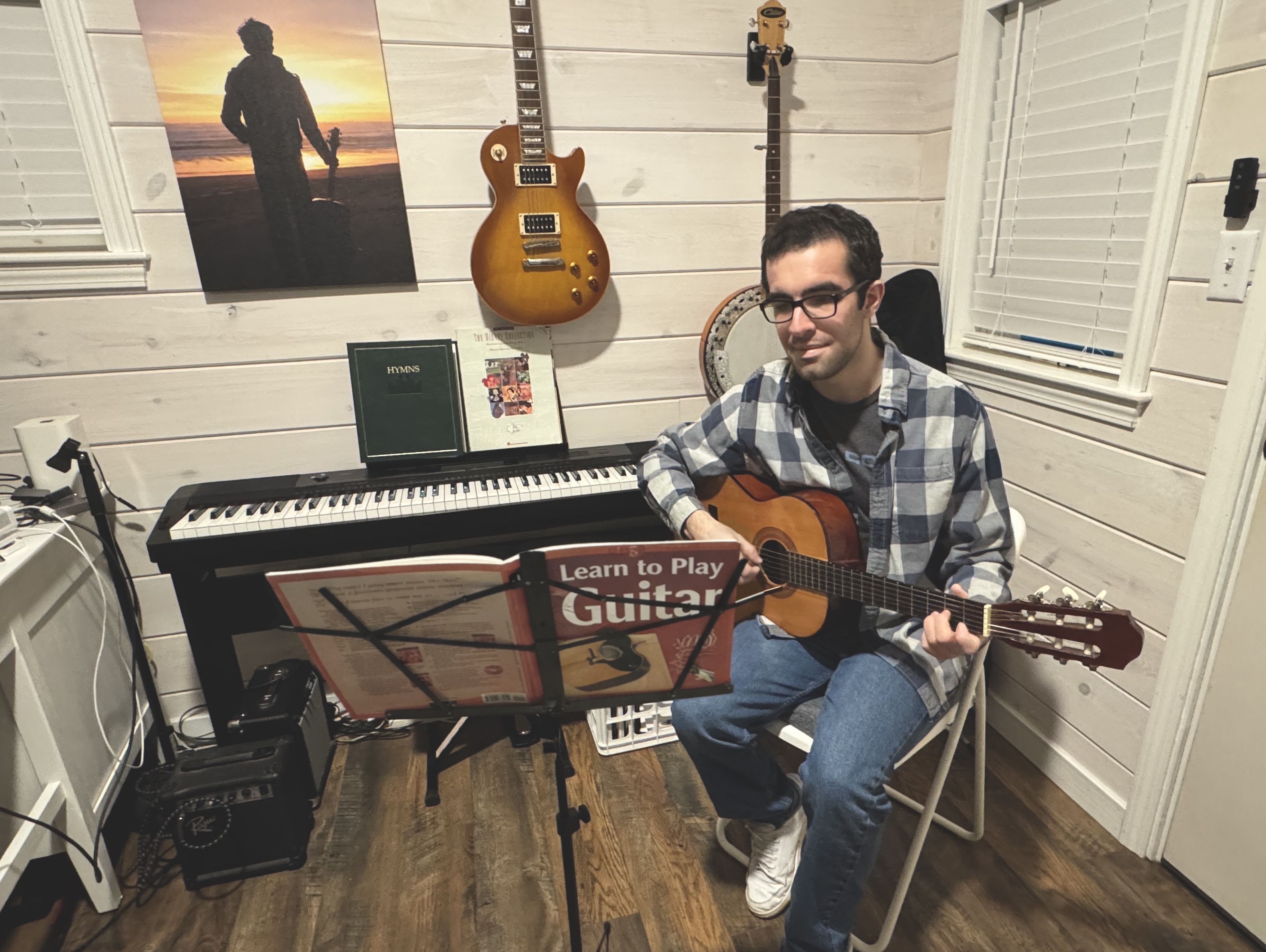 Music teacher tutoring young girl to play guitar at home